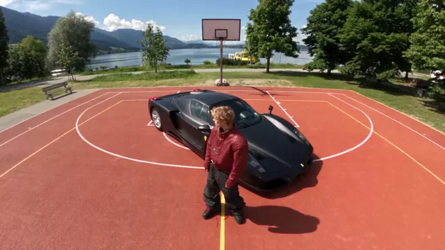 Drone overhead: from high above the court, looking down on him standing beside the black car
