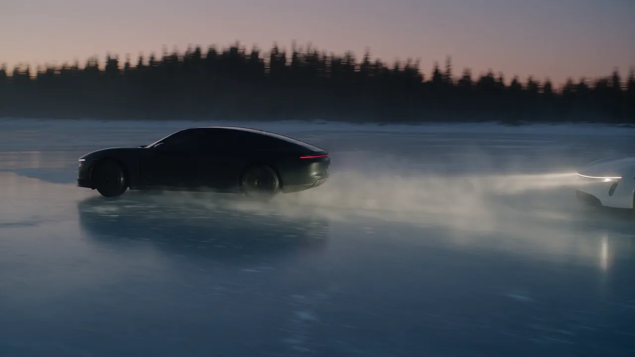 A black coupe drifts across a frozen lake at sunrise throwing snow, two white pursuit cars fishtailing behind it