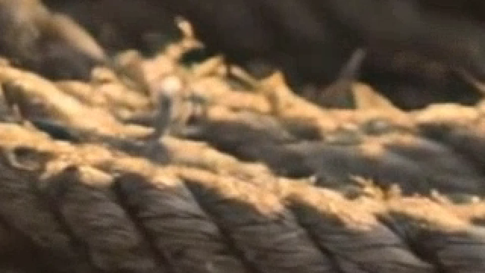 Frayed rope fibres in warm light, a 320 by 180 pixel patch of Kling v3's 4K frame shown three times larger, as delivered.