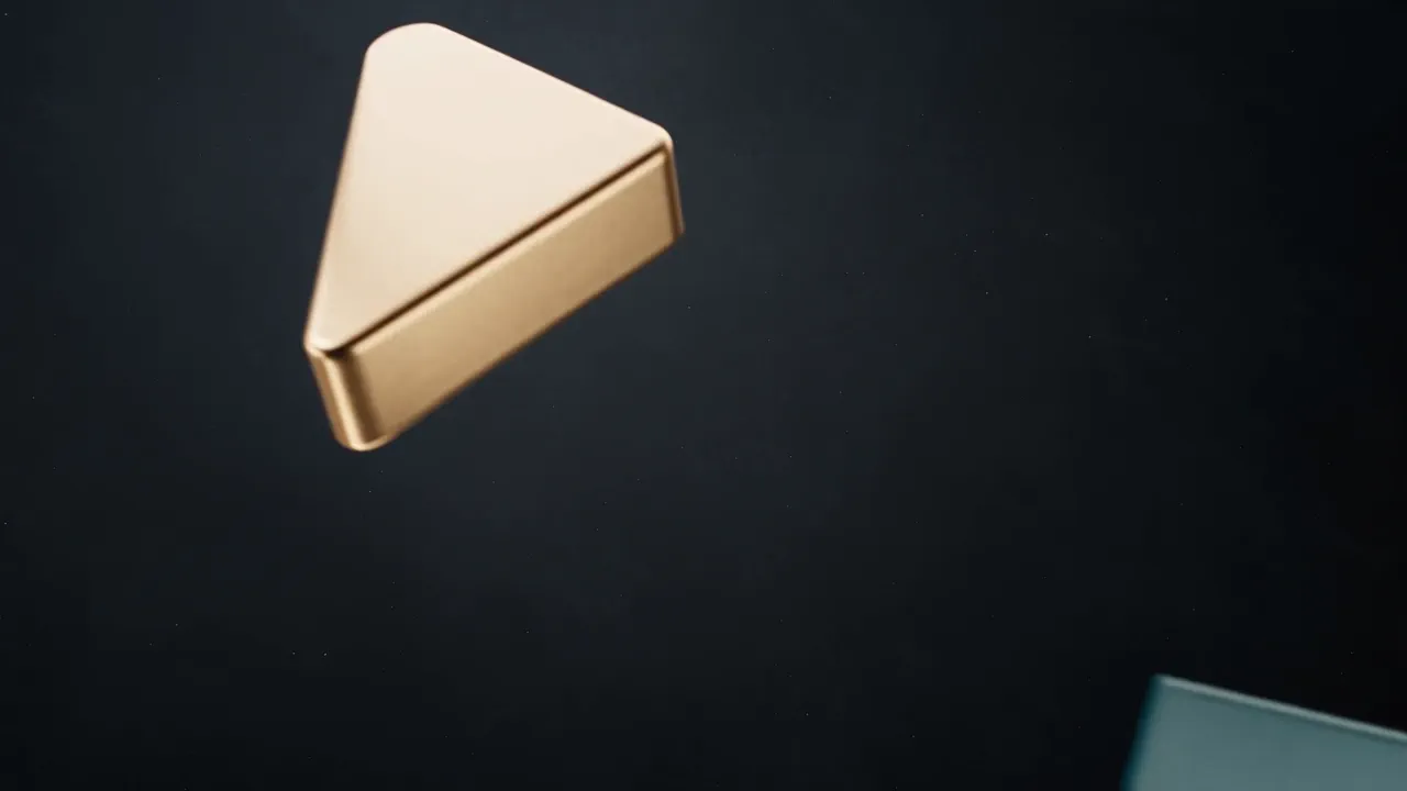 Brass, off white and teal pieces fly in over a charcoal ground and lock into one compact square mark under a warm glow