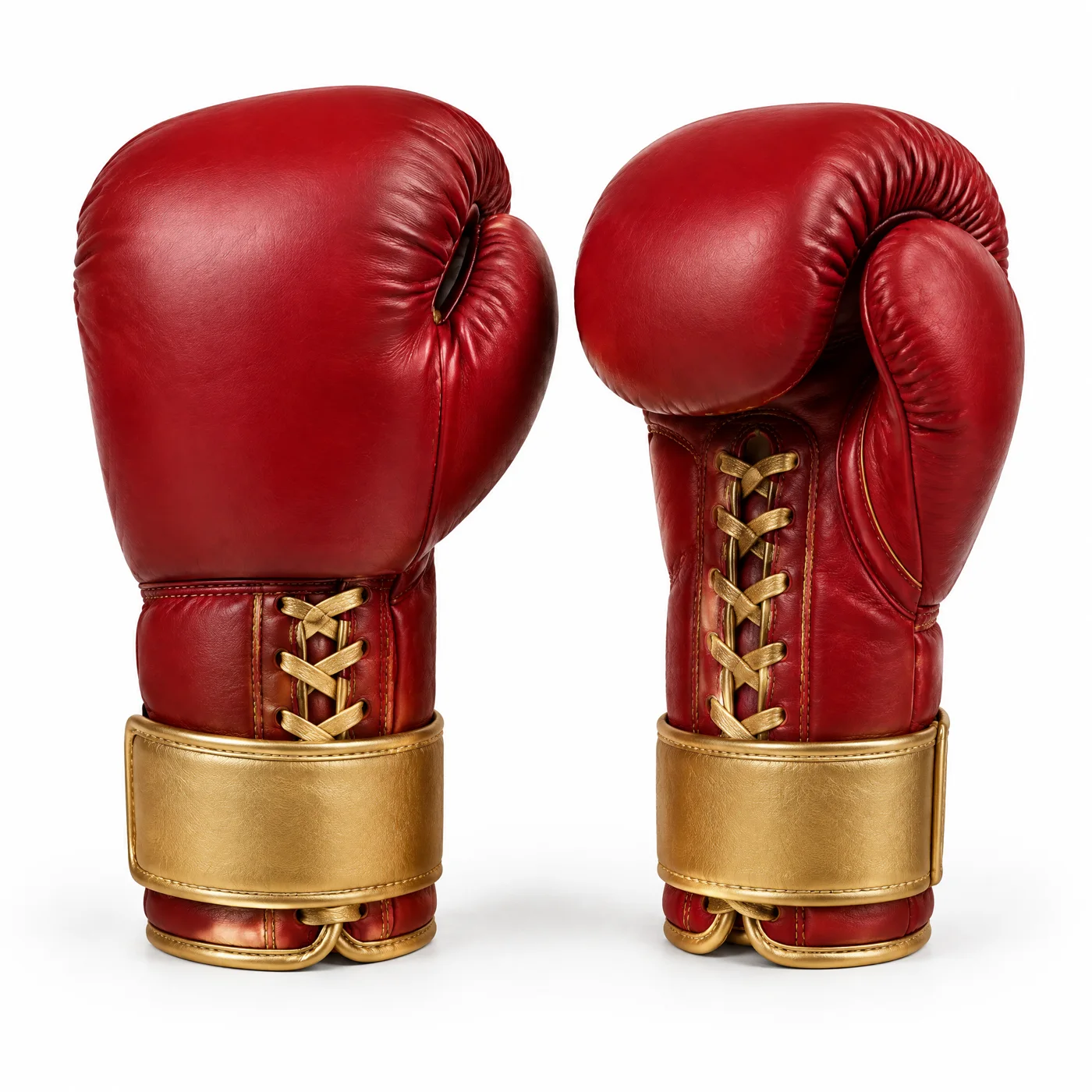 A clean product photo of a pair of crimson red leather boxing gloves with gold laces and gold wrist straps on a white background